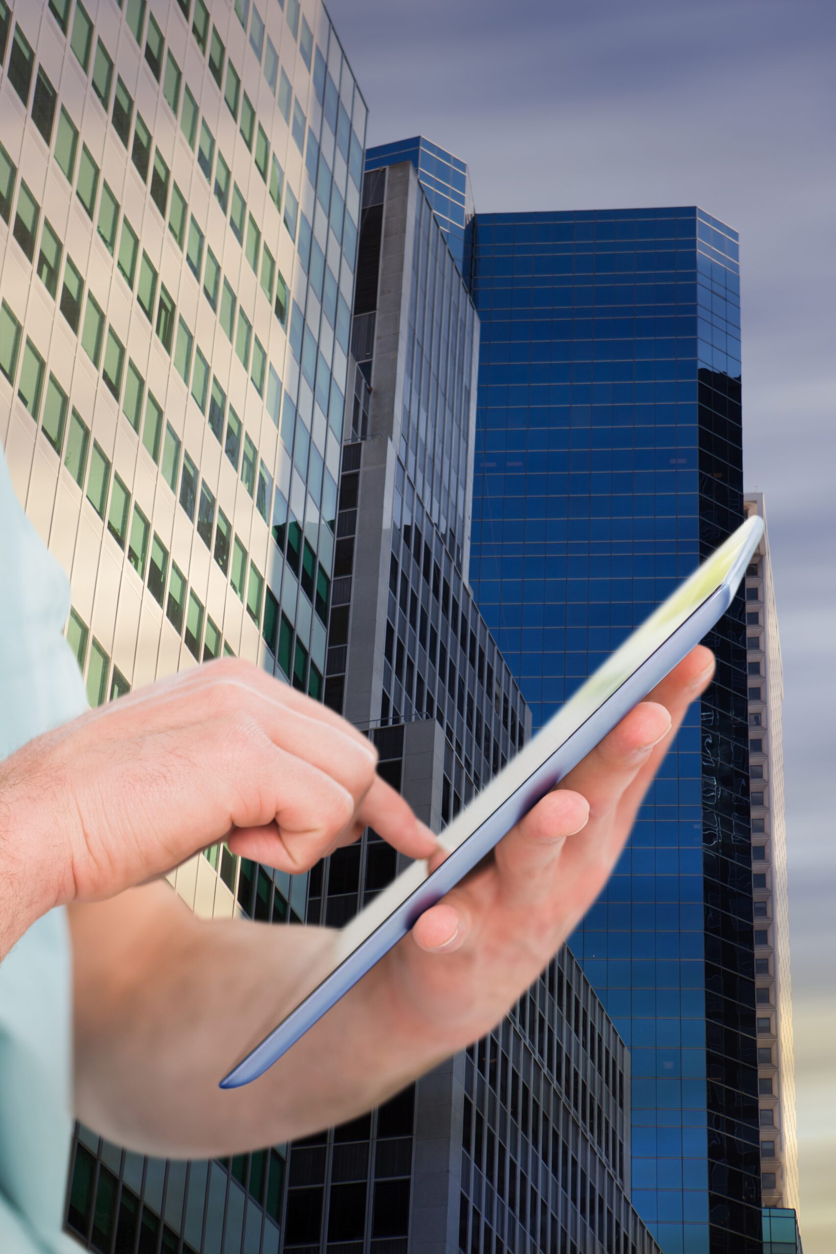 Composite image of hand man using digital tablet with city background
